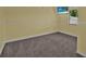 Bright room featuring plush carpeting and a window, designed for comfort and style at 837 Acorn Ln, Port Orange, FL 32127