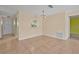 Neutral dining area with tile flooring, and a serving hatch looking into the kitchen at 837 Acorn Ln, Port Orange, FL 32127