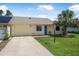 Inviting single-story house with a well-kept lawn and a sunny, yellow exterior at 837 Acorn Ln, Port Orange, FL 32127