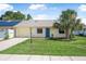 Charming single-story home with vibrant blue door and lush front lawn at 837 Acorn Ln, Port Orange, FL 32127