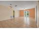 Spacious living room with neutral tones and tile flooring, perfect for entertaining at 837 Acorn Ln, Port Orange, FL 32127