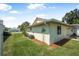 Side yard features well-maintained lawn and landscaping, with easy access to the patio at 837 Acorn Ln, Port Orange, FL 32127