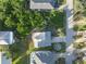 Birds eye view of the house with surrounding foliage, nearby homes, and a glimpse of the road at 895 Catfish Ave, New Smyrna Beach, FL 32169