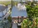 Aerial view of the home with rooftop deck and outdoor seating, landscaped yard and driveway at 895 Catfish Ave, New Smyrna Beach, FL 32169