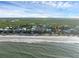 Stunning aerial view of beachfront homes, showcasing coastal living with beautiful ocean and marsh views at 895 Catfish Ave, New Smyrna Beach, FL 32169