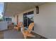 Charming covered balcony featuring two wood Adirondack chairs and sliding glass door access to indoor living at 895 Catfish Ave, New Smyrna Beach, FL 32169