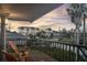 Relaxing balcony view with comfortable seating, stunning sunsets, and lush tropical scenery at 895 Catfish Ave, New Smyrna Beach, FL 32169