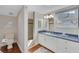 Well-lit bathroom with a walk-in shower, custom vanity with a blue countertop and hardwood flooring at 895 Catfish Ave, New Smyrna Beach, FL 32169