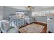 Bright bedroom featuring two beds, wood floors, and a skylight at 895 Catfish Ave, New Smyrna Beach, FL 32169