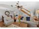 Cozy living room with vaulted ceiling, staircase, hardwood floors and comfortable seating at 895 Catfish Ave, New Smyrna Beach, FL 32169