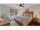 Bright main bedroom with a king bed, wood floors, and dual windows providing ample light at 895 Catfish Ave, New Smyrna Beach, FL 32169