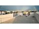 Spacious roof deck with white railings overlooking the surrounding neighborhood and a vibrant rainbow overhead at 895 Catfish Ave, New Smyrna Beach, FL 32169