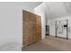 Neutral toned storage room with rattan folding screen and shelving for neatly stacked towels and robes at 895 Catfish Ave, New Smyrna Beach, FL 32169