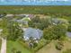 Bird's eye view of the home featuring a well-kept lawn, mature trees, fenced yard, and beautiful surroundings at 904 Clubhouse Blvd, New Smyrna Beach, FL 32168
