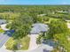 Aerial view of a beautiful home nestled among lush greenery at 904 Clubhouse Blvd, New Smyrna Beach, FL 32168