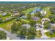 Scenic aerial of the property near a golf course showing lush greenery, mature trees, and neighborhood charm at 904 Clubhouse Blvd, New Smyrna Beach, FL 32168