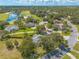 Beautiful aerial view of the property with proximity to a golf course, mature trees, and surrounding landscape at 904 Clubhouse Blvd, New Smyrna Beach, FL 32168