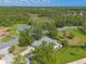 An aerial perspective of the property highlighting the private backyard patio, mature trees, and proximity to nature at 904 Clubhouse Blvd, New Smyrna Beach, FL 32168