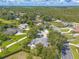 Aerial view of the property showing well-maintained landscaping, surrounding trees, and neighborhood homes at 904 Clubhouse Blvd, New Smyrna Beach, FL 32168