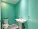 Powder bathroom with modern sink and toilet against vibrant aqua wall at 904 Clubhouse Blvd, New Smyrna Beach, FL 32168