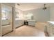Bright bathroom featuring an elegant chandelier, double vanity, bathtub, and large mirrors at 904 Clubhouse Blvd, New Smyrna Beach, FL 32168
