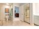 Neutral bathroom with tile floors, pebble shower basin, shower, and access to bedroom beyond at 904 Clubhouse Blvd, New Smyrna Beach, FL 32168
