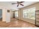 Bright bedroom featuring wood-look flooring, mirrored closet, and large windows providing ample natural light at 904 Clubhouse Blvd, New Smyrna Beach, FL 32168