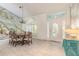 Bright dining room with unique wall art, chandelier, tile floors and view into entry at 904 Clubhouse Blvd, New Smyrna Beach, FL 32168