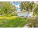 Charming home with light blue facade, enhanced by lush landscaping and a well-maintained lawn at 904 Clubhouse Blvd, New Smyrna Beach, FL 32168