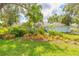 Well maintained front yard with native Florida landscaping featuring palm trees and flowering shrubs at 904 Clubhouse Blvd, New Smyrna Beach, FL 32168