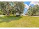 Spacious front yard showcases mature trees and meticulous landscaping enhancing the property's curb appeal at 904 Clubhouse Blvd, New Smyrna Beach, FL 32168