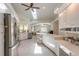 Well-lit kitchen featuring white cabinetry, stainless steel appliances, and an open concept design at 904 Clubhouse Blvd, New Smyrna Beach, FL 32168