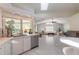 Kitchen with white cabinets, quartz countertops, stainless appliances, and a view into the living area at 904 Clubhouse Blvd, New Smyrna Beach, FL 32168