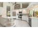Bright, modern kitchen featuring white cabinetry, stainless steel appliances, and tile flooring at 904 Clubhouse Blvd, New Smyrna Beach, FL 32168
