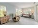 Comfortable living room with tile floors, neutral walls, and bright natural light from multiple shuttered windows at 904 Clubhouse Blvd, New Smyrna Beach, FL 32168
