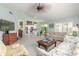 Open living room showcasing tile flooring, light-filled ambiance, and a view of the kitchen area at 904 Clubhouse Blvd, New Smyrna Beach, FL 32168