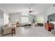 Open living room with vaulted ceiling, plantation shutters, and light-colored tile flooring at 904 Clubhouse Blvd, New Smyrna Beach, FL 32168