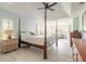 A stylish bedroom with a four-poster bed, complemented by natural light from shuttered windows at 904 Clubhouse Blvd, New Smyrna Beach, FL 32168
