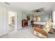 Spacious main bedroom with tray ceiling, tile floors, a four-poster bed and an adjacent sitting area at 904 Clubhouse Blvd, New Smyrna Beach, FL 32168