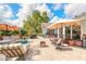 Brick patio with seating areas, grill, and access to house and backyard at 904 Clubhouse Blvd, New Smyrna Beach, FL 32168
