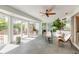 Sunroom with tile flooring, ceiling fan, and sliding glass doors to the backyard patio at 904 Clubhouse Blvd, New Smyrna Beach, FL 32168