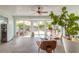 Bright sunroom featuring tile flooring, ceiling fan, and sliding glass doors leading to outdoor patio at 904 Clubhouse Blvd, New Smyrna Beach, FL 32168