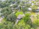 Aerial view of a home with lush trees and waterway access at 154 Godfrey Rd, Edgewater, FL 32141