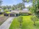 Stunning home with manicured lawn and mature trees, offering a serene setting and enhanced privacy on a peaceful lot at 154 Godfrey Rd, Edgewater, FL 32141