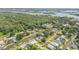 Aerial view featuring canal-front homes nestled among a densely wooded neighborhood at 154 Godfrey Rd, Edgewater, FL 32141