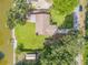 Aerial view of the house highlighting the expansive lawn, canal access, and proximity to the water at 154 Godfrey Rd, Edgewater, FL 32141