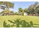 Spacious backyard featuring manicured lawn, wooden fences, mature trees, and a storage shed at 154 Godfrey Rd, Edgewater, FL 32141