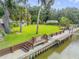 Backyard view features a wooden dock and canal access to the home at 154 Godfrey Rd, Edgewater, FL 32141