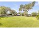 Large, grassy backyard with mature trees and waterfront access at 154 Godfrey Rd, Edgewater, FL 32141