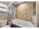 Cozy bathroom featuring a jetted tub with shower, tiled backsplash, and an arched ceiling at 154 Godfrey Rd, Edgewater, FL 32141